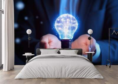 Businessman holding virtual light bulb with 2 hands, smart thinking idea. Wall mural