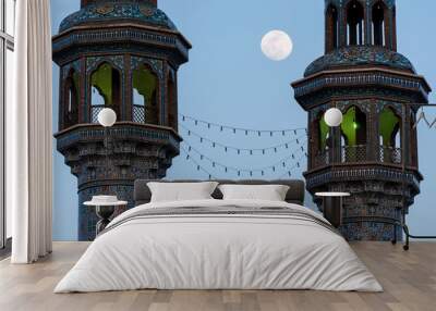 Colorful tiled tower of two minarets with the moon on the background, Qom, Iran. Wall mural