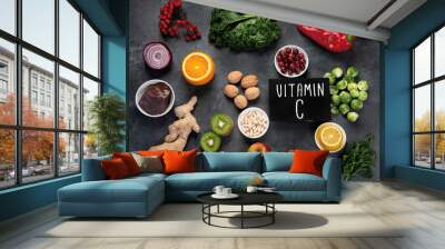 Foods high in vitamin C on dark background. Wall mural