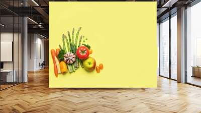 Fresh fruits and vegetables on yellow background Wall mural