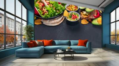 Hispanic mexican food, nachos, guacamole, meat tacos on dark background Wall mural