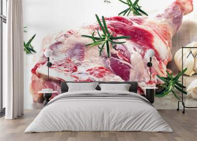 Raw lamb leg on a wooden cutting board. Wall mural