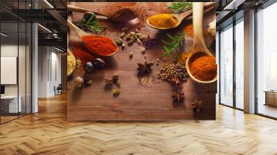 Spices and herbs on wooden table. Wall mural