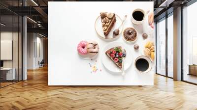 Table with various cookies, donuts, cakes,  coffee cups on white  background. Wall mural