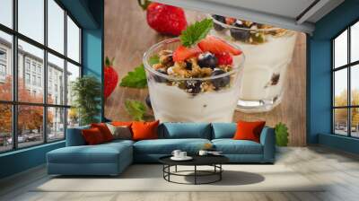 Yogurt with Granola  and fresh berries on a rustic wooden backgr Wall mural