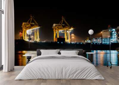 Cargo ship unloading the container at Port during the night time Wall mural