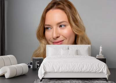 Portrait of young pretty cheerful girl smiling looking at camera over monochromatic background. Wall mural