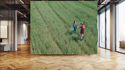 Banker and farmer negotiating bank agriculture loan in wheat field, aerial view Wall mural