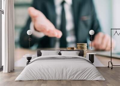 Banker offering financial loan, closeup of white collar business person in office with stacked coins Wall mural