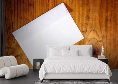 Blank white envelope on wooden desk Wall mural