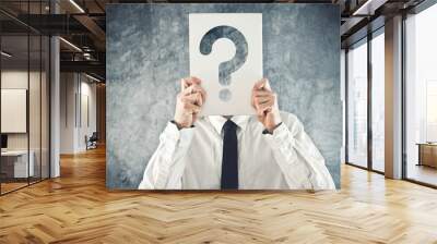 Businessman holding paper with printed question mark Wall mural