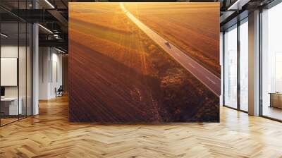 Cars driving down the road through countryside in autumn Wall mural