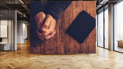 Christian man praying with hands crossed Wall mural