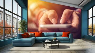 Close up of hands using mobile phone Wall mural