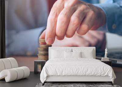 Coin stacker, businessman with stacked money Wall mural