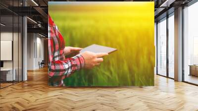 Female farmer using tablet in wheat crop field Wall mural