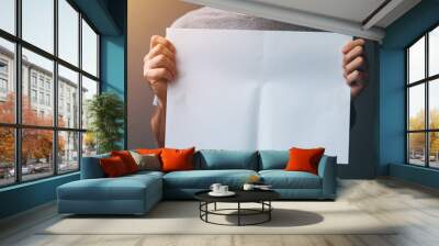 Man holding blank paper Wall mural