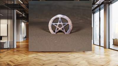 Wooden encircled Pentagram symbol on the beach at sunrise in front of the lake. Concept of Five elements: Earth, Water, Air, Fire, Spirit. Wall mural