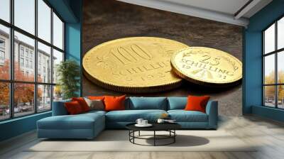 austrian 25 and 100 schilling gold coins on rustic wooden background Wall mural