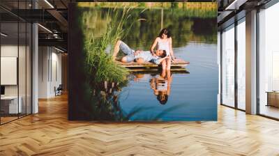 young love couple at the lake in summer sunset Wall mural