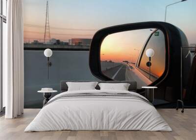 Beautiful sunset reflect in mirror of car. Wall mural