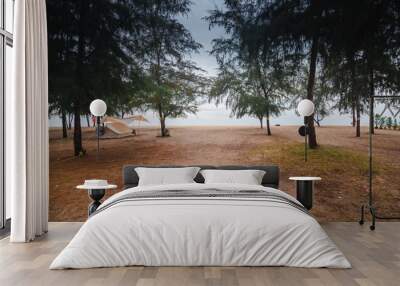 Tourist tents under the pine trees on the sand, camping on a beach vacation in Thailand. Wall mural