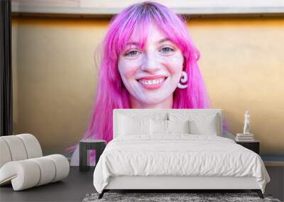 close up portrait of alternative woman withpink hair hanging out chilling and smiling standing isolated against  modern wood background wall. happy girl smiling at camera relaxing. lifestyle concept Wall mural