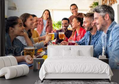 happy diverse large group of multicultural friends having salty breakfast brunch together at bar restaurant indoors. convivial people talking sitting on a table at home having fun. lifestyle concept Wall mural