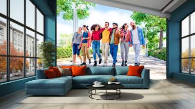 multiethnic group of friends walking in the street outdoors laughing and having fun. diverse people celebrating life together enjoying happy summer holidays. lifestyle, travel and togetherness concept Wall mural