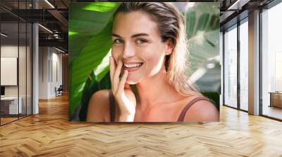 Beautiful and  natural looking woman with tropical banana leaves Wall mural