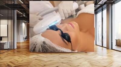 beautiful woman in beauty salon during photo rejuvenation procedure Wall mural