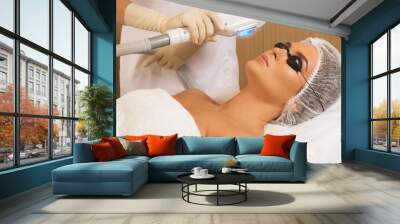 beautiful woman in beauty salon during photo rejuvenation procedure Wall mural