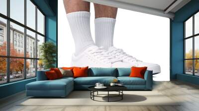 Closeup of male feet and shoes. Man wearing white trainers on white background. Wall mural