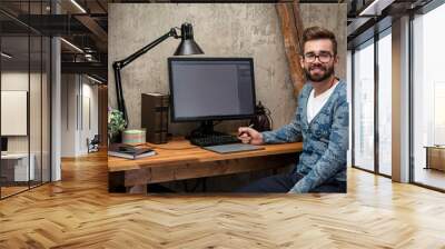 Graphic designer at his workplace Wall mural