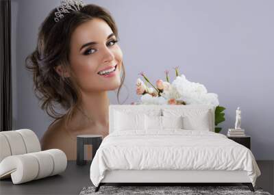 Portrait of young beautiful bride with bouquet of flowers Wall mural