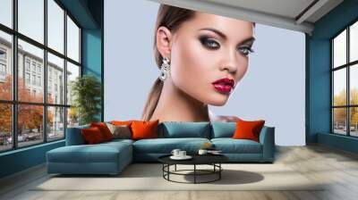 Portrait of young woman with beautiful earrings Wall mural