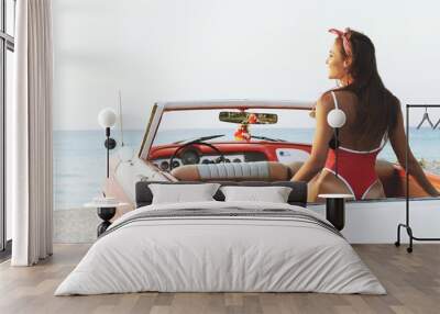 sexy woman in red swimsuit and retro cabriolet car Wall mural