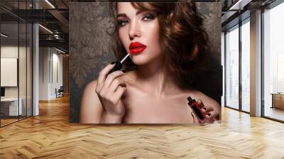 Woman applying red lipstick Wall mural