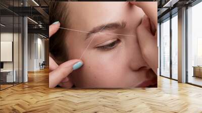 woman during eyebrow threading Wall mural