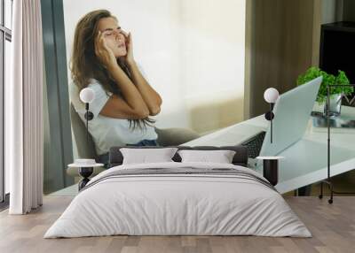 Woman with headache in office Wall mural