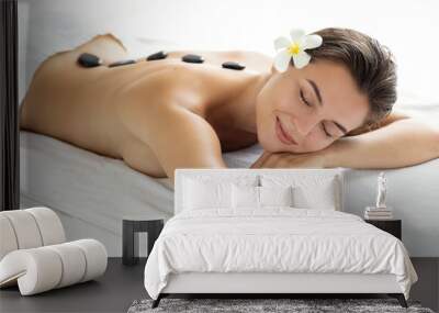 Young and beautiful woman during hot stones massage Wall mural