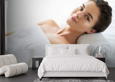 Young and beautiful woman is lying and relaxing after massage session Wall mural