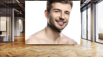 Young and handsome man with smooth skin on white background Wall mural