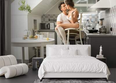 Young couple  kissing on the kitchen Wall mural