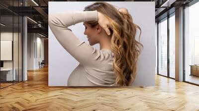 Young woman showing her beautiful hair after dyeing and styling Wall mural