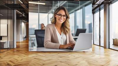  Happy casual beautiful woman working on a laptop in the office. Wall mural