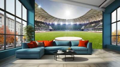 podium in the center of a stadium, surrounded by rows of empty seats and light flashes. The podium is simple and perfect to show your product, the playground of grass inside the soccer football Wall mural