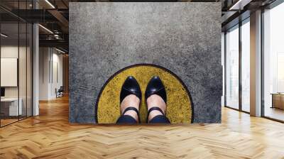 Comfort Zone Concept, Woman with leather shoes Standing inside a Circle Bound, Top view and Dark tone, Grunge Dirty Concrete Floor as Background Wall mural