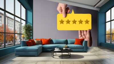 Customer Experience Concept, Happy Client giving Five Star Rating Feedback on Card to a Businessman. Top View Wall mural