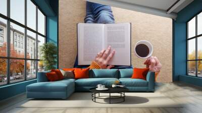 Reading Concept. Soft Focus of  Young Woman Relaxing by Book and Coffee in Cozy House, Sit on the Floor, Top View Wall mural